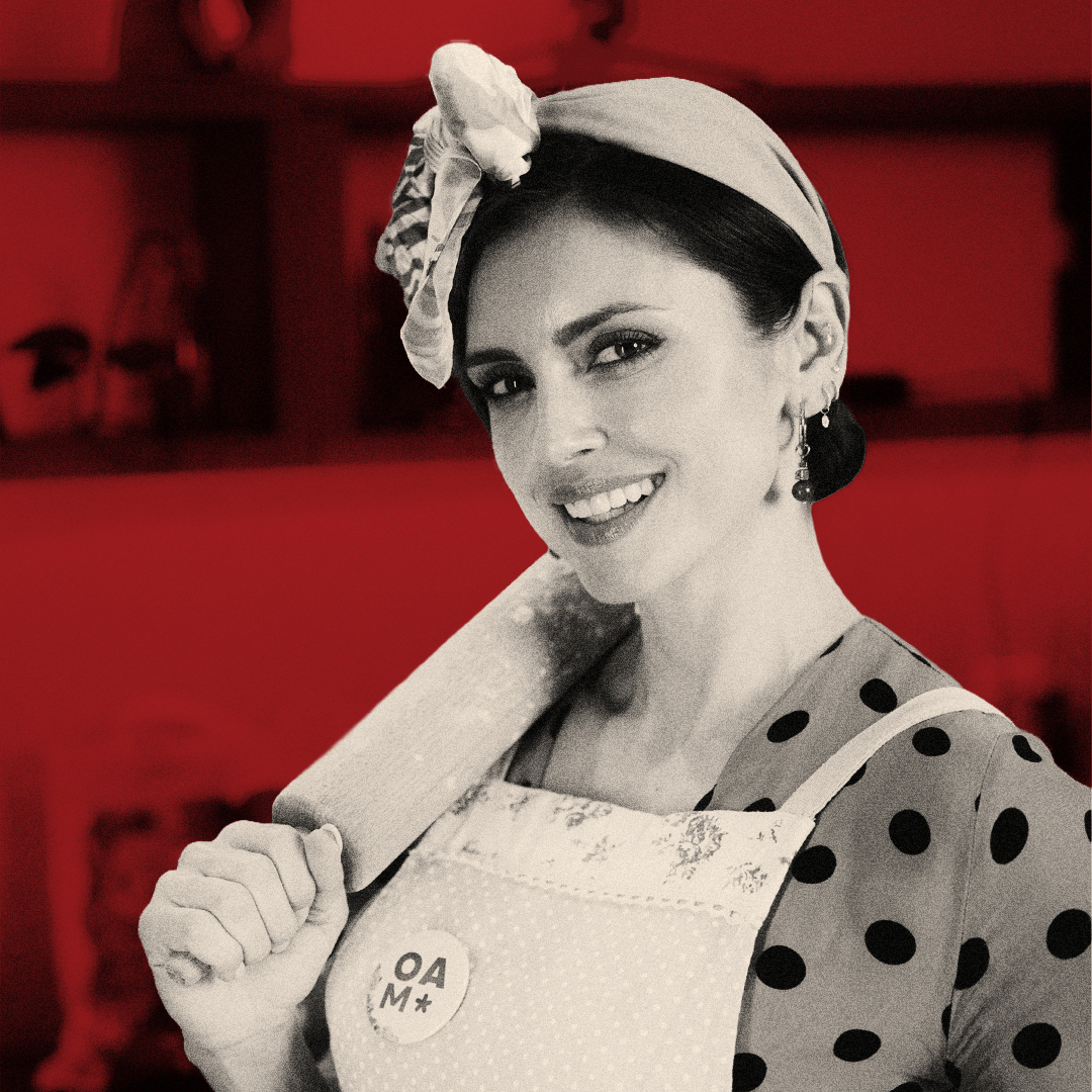 Portrait of a smiling woman wearing an apron and headscarf against a red background