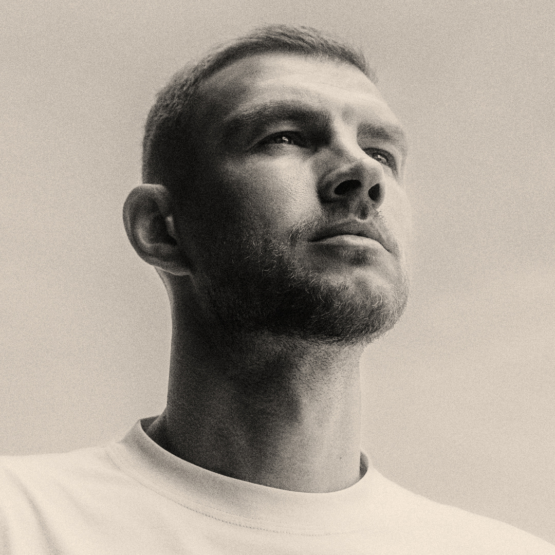 Black-and-white close-up portrait of a man looking upward